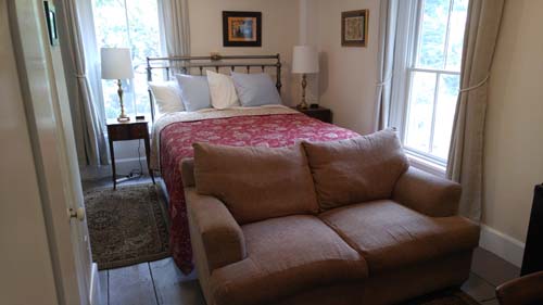 love seat, queen bed, nightstands,
				2 large windows